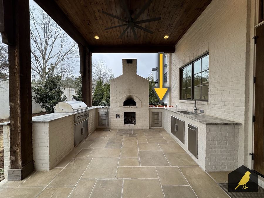 Outdoor kitchen counter pitched toward the house
