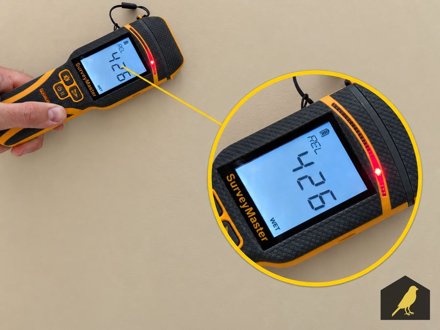 Moisture meter reading 42.6 percent on an interior wall