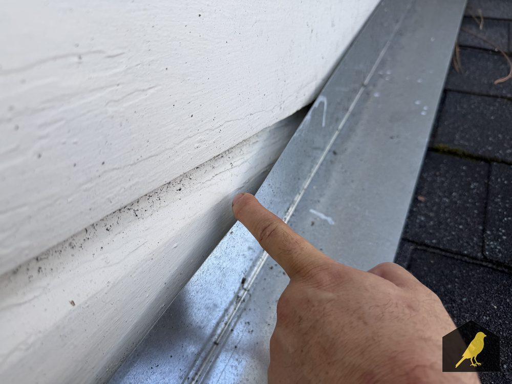 Gap and staining at a wall-to-roof flashing joint