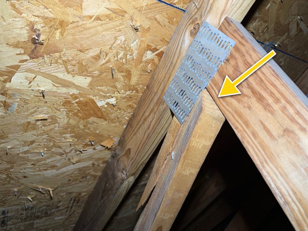 Close-up of a splitting truss connection with a metal gusset plate